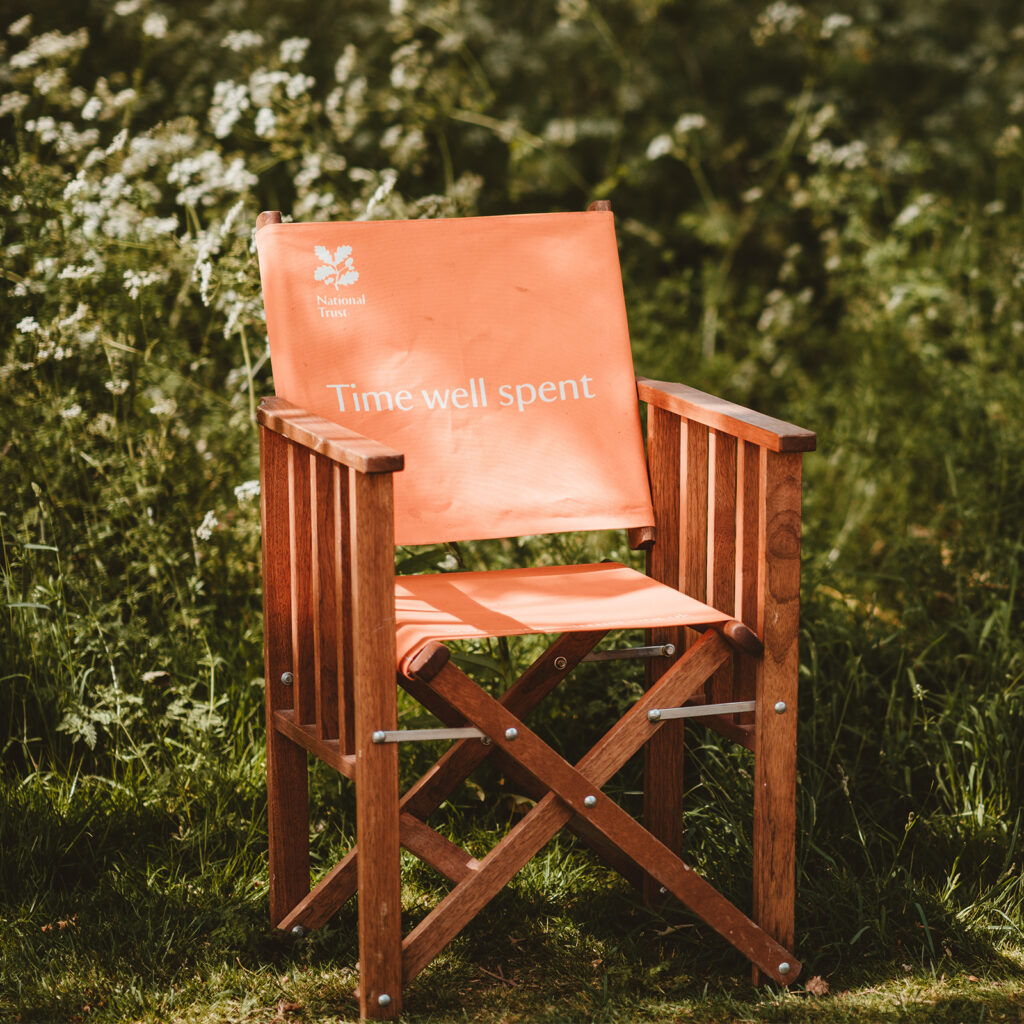 Deck chair in woodland with words "Time well spent" printed on it