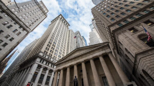 Upwards view of skyscrapers against cloudy blue sky