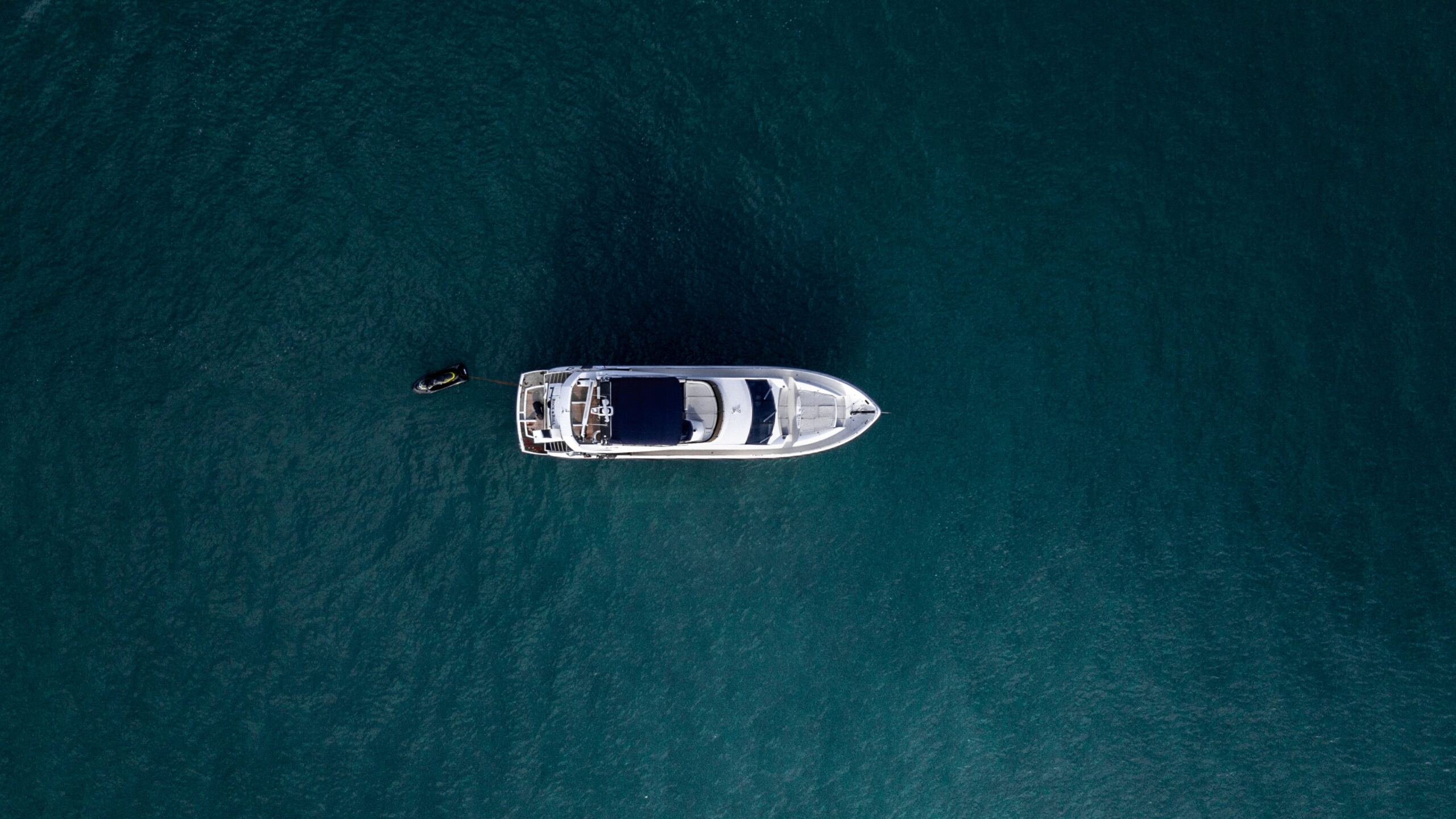 Aerial view of lone yacht in expanse of ocean