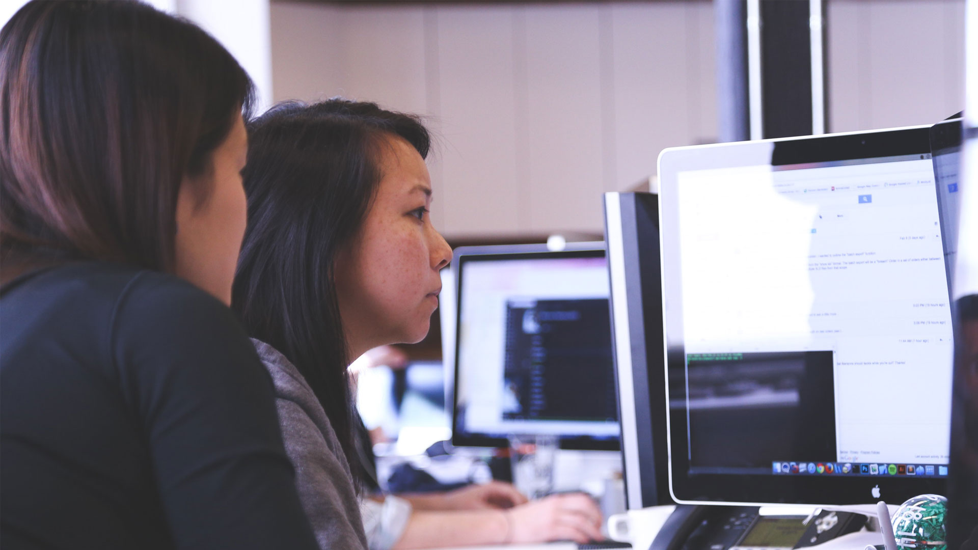 Two people looking at a computer screen