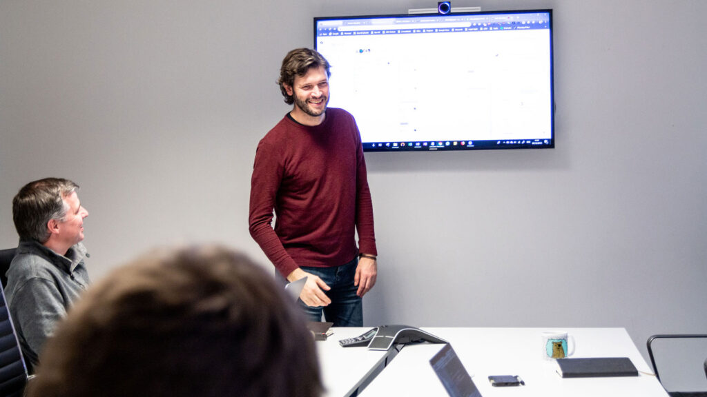 Person walking through project board at meeting