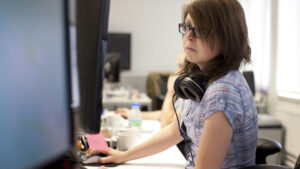 Person using a mouse in front of a computer screen