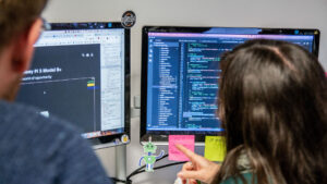 Shot of two people looking at computer screens